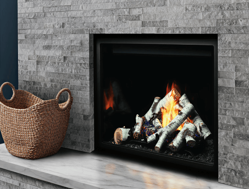 A cozy gas fireplace with glowing logs set in a stone wall emits a warm flame. A woven basket sits on the stone hearth nearby, creating a homely ambiance.